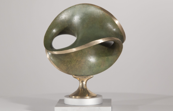 Alt text: Round bronze sculpture