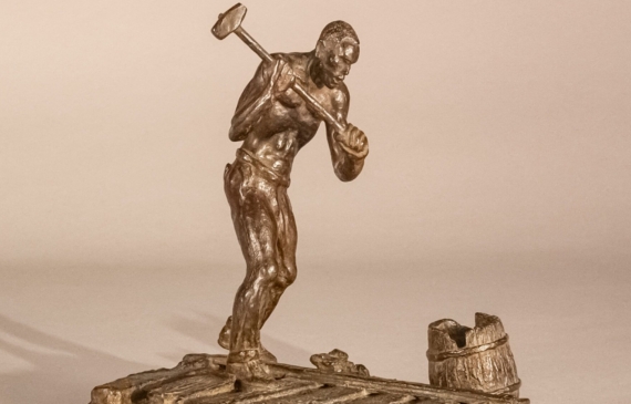 Alt text: Bronze sculpture of a railroad worker