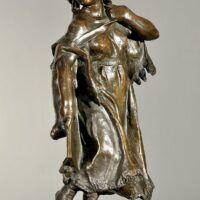 Alt text: Bronze sculpture of a young girl with a baby on her back