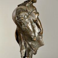 Alt text: Bronze sculpture of a young girl with a baby on her back