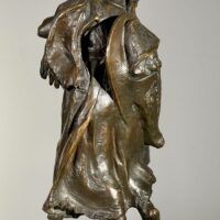 Alt text: Bronze sculpture of a young girl with a baby on her back