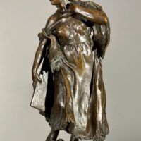 Alt text: Bronze sculpture of a young girl with a baby on her back