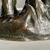 Alt text: Bronze sculpture, foundry mark detail