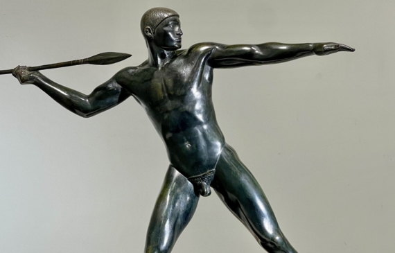 Alt text: Bronze sculpture of man with a spear