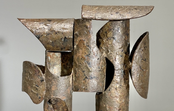 Alt text: Abstract steel and bronze sculpture