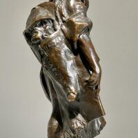 Alt text: Bronze sculpture of a young girl with a baby on her back