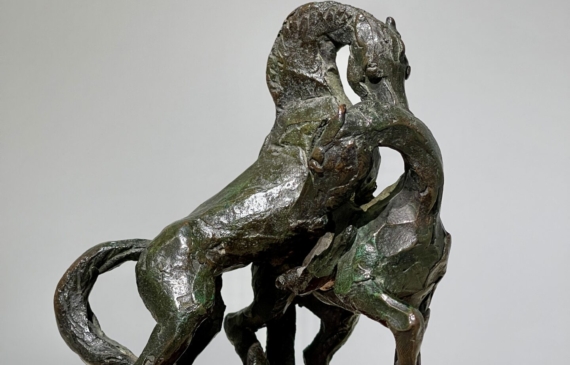 Alt text: Bronze sculpture of two stallions fighting