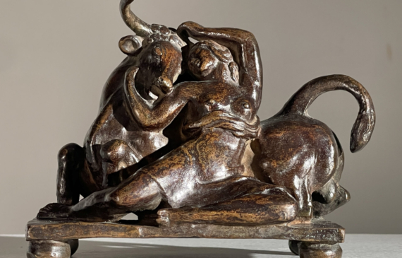 Alt text: Bronze sculpture of a woman with a bull