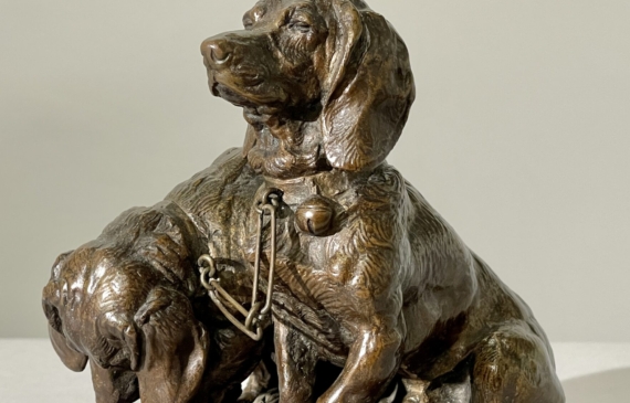 Alt text: Bronze sculpture of two dogs