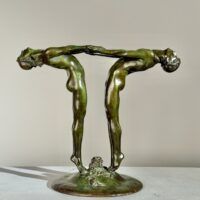 Alt text: Bronze sculpture of two figures holding hands