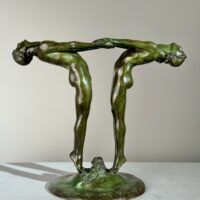 Alt text: Bronze sculpture of two figures holding hands