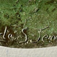 Alt text: Bronze sculpture, signature detail