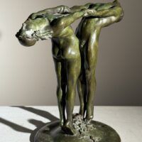 Alt text: Bronze sculpture of two figures holding hands