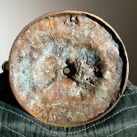 Alt text: Bronze sculpture, underside detail