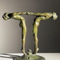 Alt text: Bronze sculpture of two figures holding hands