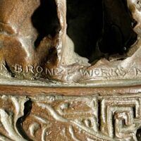 Alt text: Bronze sculpture foundry mark detail