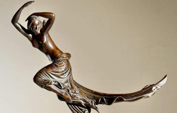 Alt text: Bronze sculpture of a semi-nude female figure