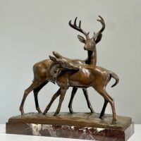 Alt text: Bronze sculpture of two deer