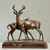 Alt text: Bronze sculpture of two deer