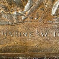 Alt text: Bronze sculpture, signature detail