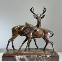 Alt text: Bronze sculpture of two deer
