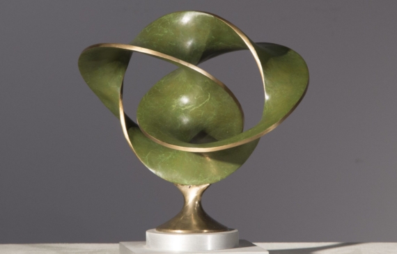 Alt text: Abstract bronze sculpture of three distorted and conjoined circles