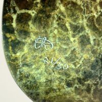 Alt text: Bronze sculpture, signature detail