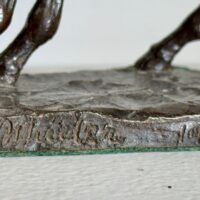 Alt text: Bronze sculpture, signature detail