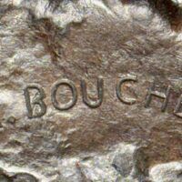 Alt text: Bronze sculpture, signature detail