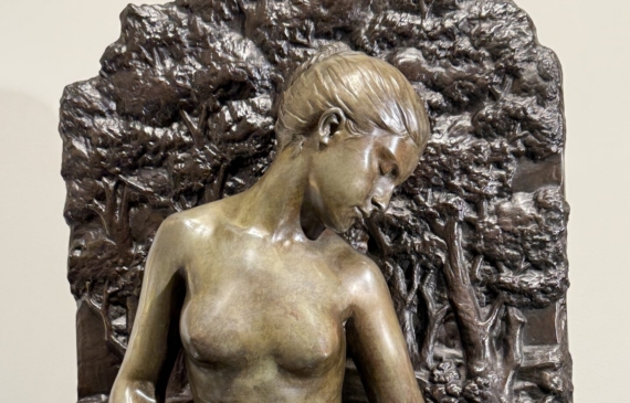 Alt text: Bronze sculpture of a woman