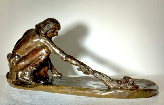 Alt text: Bronze sculpture of a crouching man with outstretched arm