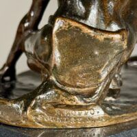 Alt text: Bronze sculpture, foundry mark detail