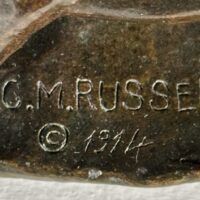 Alt text: Bronze sculpture, signature detail