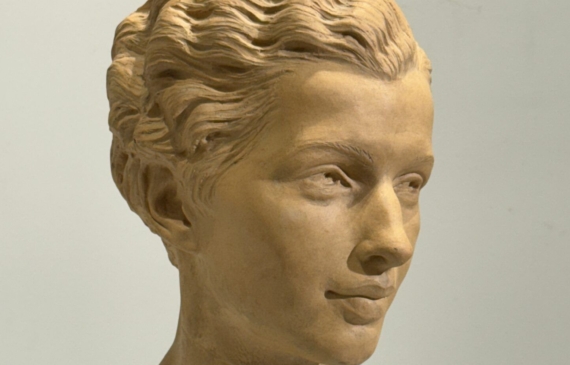 Alt text: Terracotta bust of a young woman's face