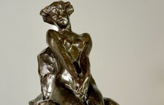 Alt text: Bronze sculpture of a nude woman sitting and reclining