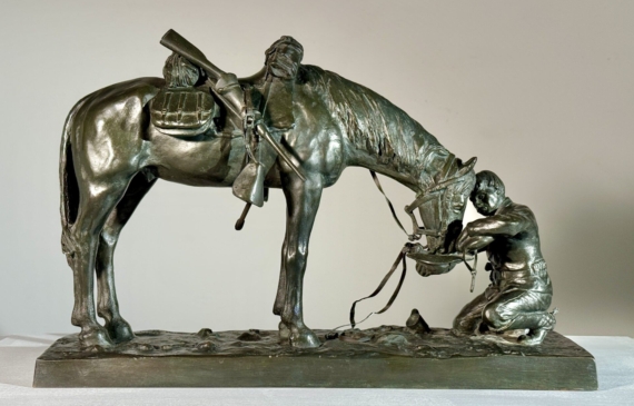 Alt text: Bronze sculpture of a figure kneeling in front of a horse