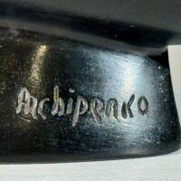 Alt text: Sculpture, signature detail