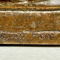 Alt text: Bronze sculpture, foundry mark detail