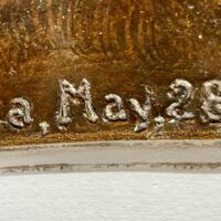 Alt text: Bronze sculpture, signature detail