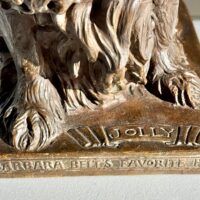 Alt text: Bronze sculpture, title and inscription detail
