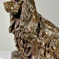 Alt text: Bronze sculpture of a seated dog