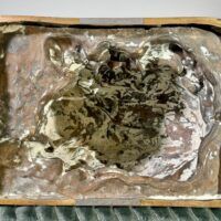 Alt text: Bronze sculpture, underside view