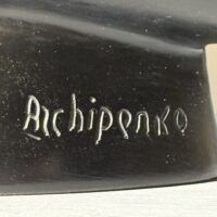 Alt text: Black sculpture, signature detail