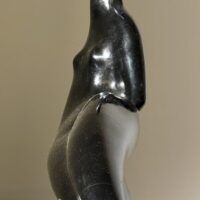 Alt text: Abstracted sculpture of a reclining nude figure, side view