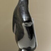 Alt text: Abstracted sculpture of a reclining nude figure, side view