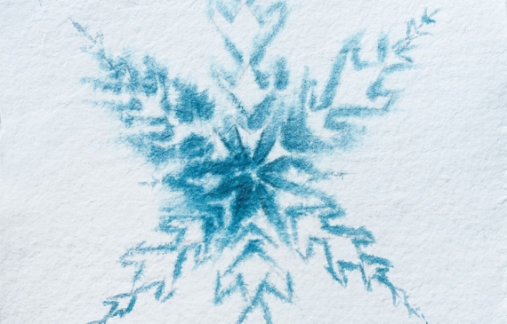 Alt text: watercolor painting of a snowflake in blue and white