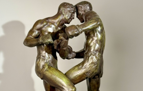 Alt text: Bronze sculpture of two boxers engaged in a fight