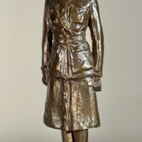 Alt text: Bronze sculpture of a woman in uniform