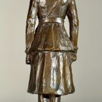 Alt text: Bronze sculpture of a woman in uniform