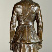 Alt text: Bronze sculpture of a woman in uniform